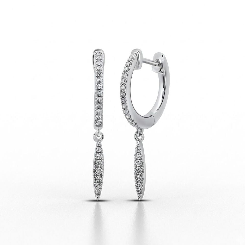 The 10k White Gold Diamond Drop Dangle Earrings feature small round diamonds and dangling marquise-shaped charms encrusted with diamonds, shown elegantly against a white background.