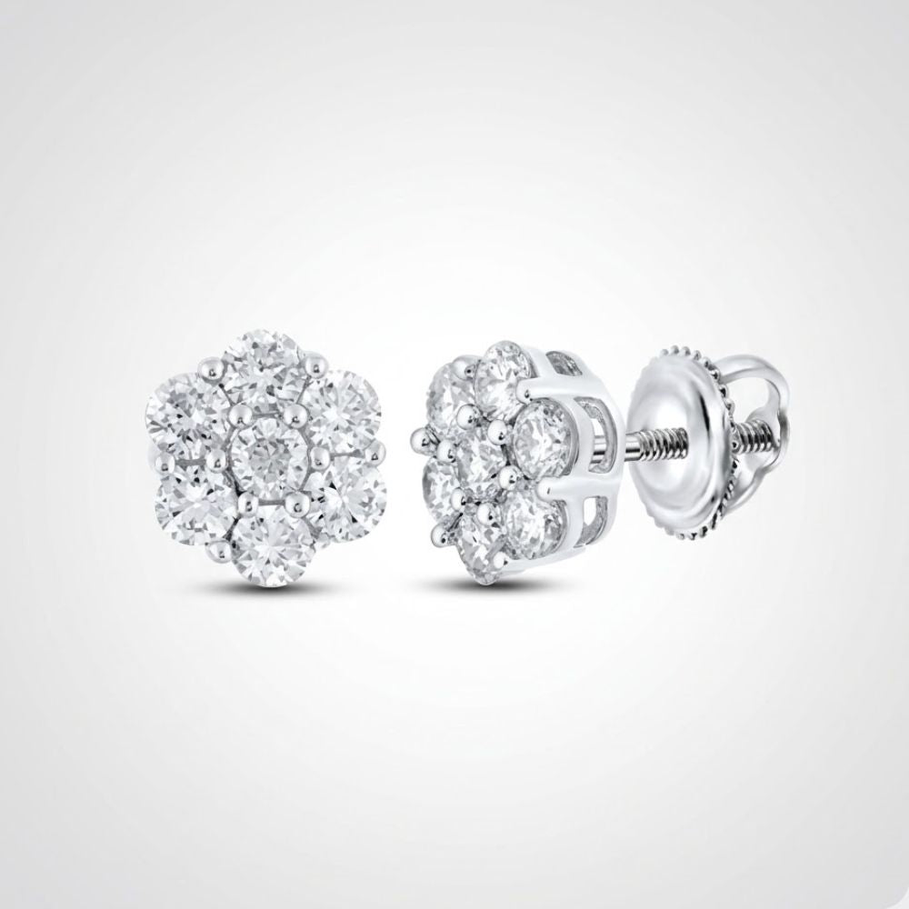 A pair of 10k gold diamond flower cluster earrings, totaling 1 cttw and set in a floral design, with screw-back posts, displayed on a plain light grey background.