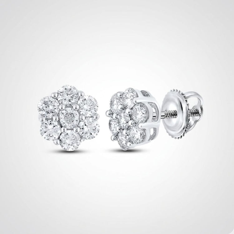 A pair of 10k gold diamond flower cluster earrings, totaling 1 cttw and set in a floral design, with screw-back posts, displayed on a plain light grey background.