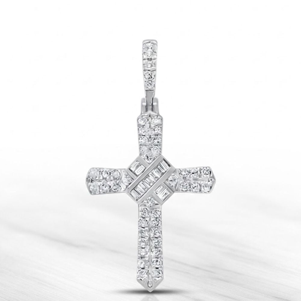 The 1/4 CT Natural Diamond Cross Pendant in 10K gold features sparkling round and baguette-cut diamonds in elegant rows, displayed on a marble-like background—ideal for anyone who values meaningful spiritual jewelry.