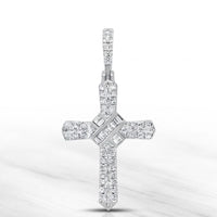 The 1/4 CT Natural Diamond Cross Pendant in 10K gold features sparkling round and baguette-cut diamonds in elegant rows, displayed on a marble-like background—ideal for anyone who values meaningful spiritual jewelry.