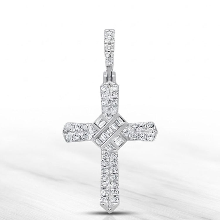 The 1/4 CT Natural Diamond Cross Pendant in 10K gold features sparkling round and baguette-cut diamonds in elegant rows, displayed on a marble-like background—ideal for anyone who values meaningful spiritual jewelry.
