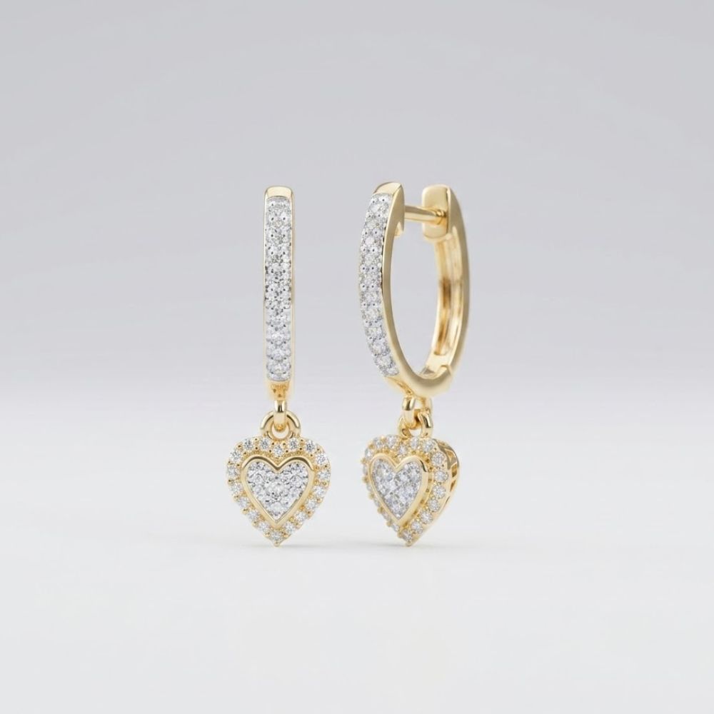 10k Gold Diamond Heart Hoop Dangle Earrings 1/4 Cttw feature sparkling stones and dangling heart-shaped charms, each with additional stones. These elegant earrings are shown against a plain, light background.