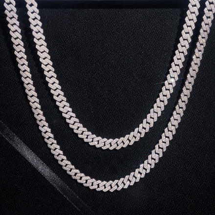 Two Moissanite Cuban Links Chains, each 8mm and crafted from 925 sterling silver, are displayed against a black background. The chains showcase a sparkling, textured finish and are elegantly arranged in parallel curves.