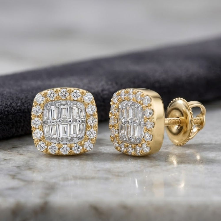 The 1/4CTW Natural Diamond Cushion Baguette Earrings in 10K gold feature a cushion baguette cluster design with both baguette and round natural diamonds, beautifully displayed on a marble surface with a black cloth in the background.