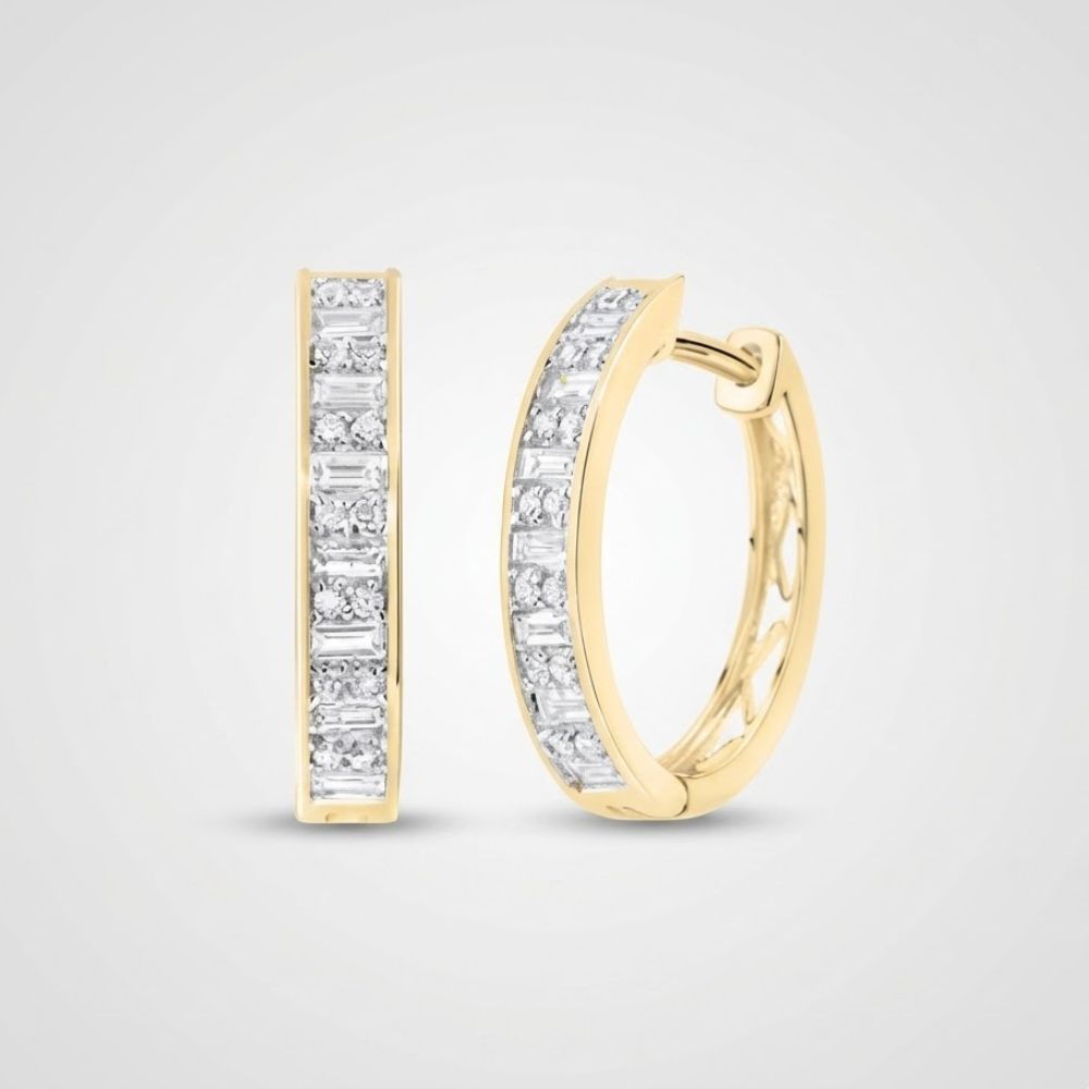 The 1/2CTW Diamond Baguette Hoop Earrings in 14K gold are shown, each featuring a row of rectangular white diamonds along the front, displayed against a plain light gray background.