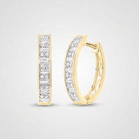 The 1/2CTW Diamond Baguette Hoop Earrings in 14K gold are shown, each featuring a row of rectangular white diamonds along the front, displayed against a plain light gray background.