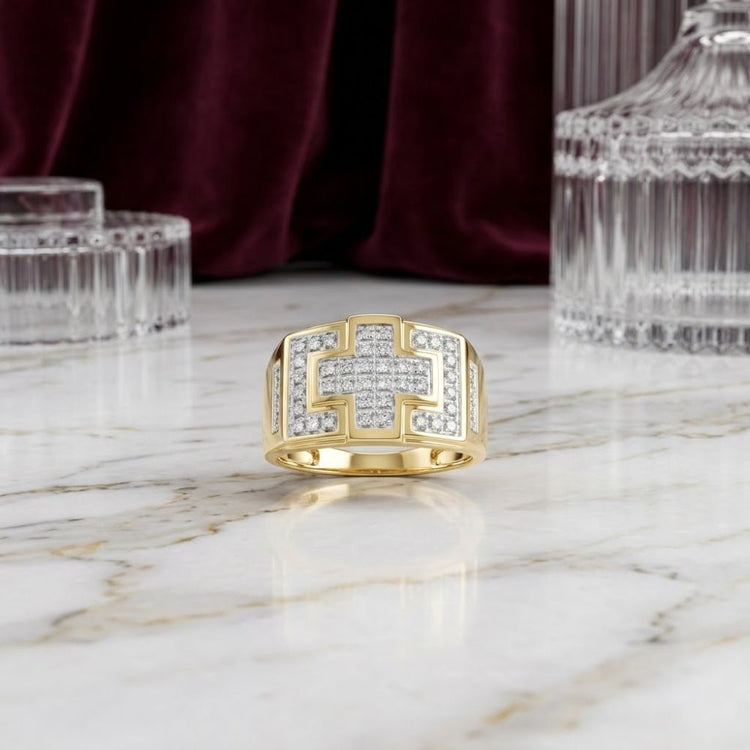 A 10k Gold Diamond Cross Cluster Ring (1/3 Cttw) is elegantly displayed on a marble surface, surrounded by crystal glassware and set against a deep burgundy velvet backdrop.