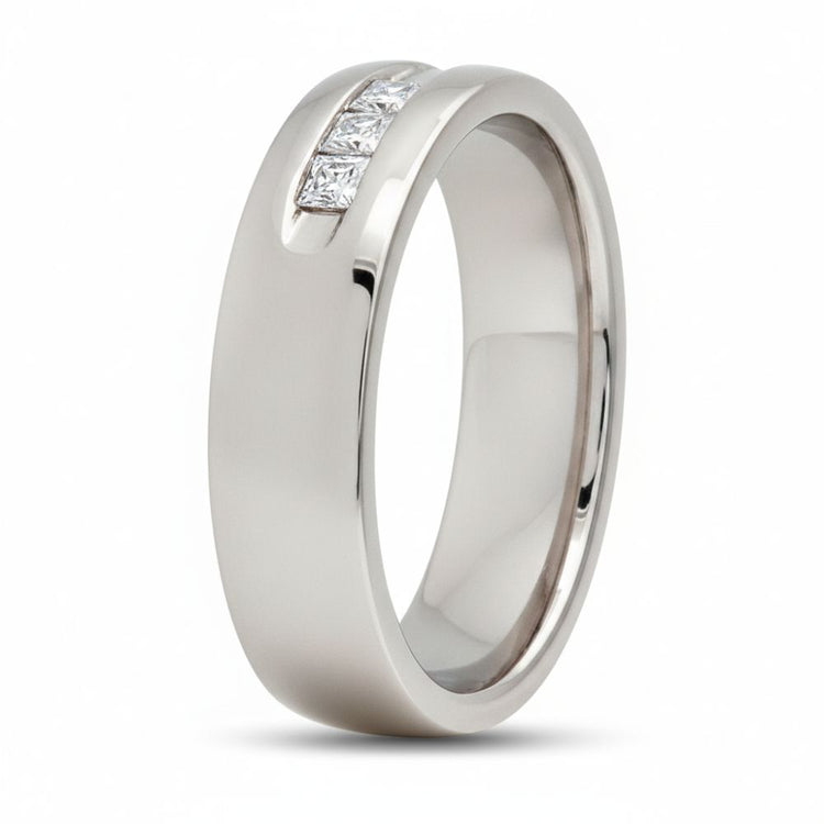 The 14k White Gold Princess Diamond Wedding Band 1/2 Cttw features a smooth, polished band set with three square-cut princess diamonds in a groove, all showcased against a plain white background.