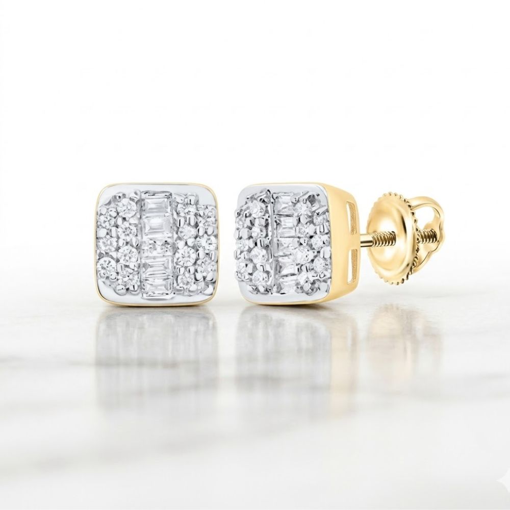 The 10k Gold Cushion Diamond Earrings 1/4 Cttw feature sparkling round and baguette-cut diamonds set in gold, showcased on a white marble surface.