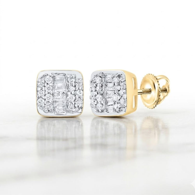 The 10k Gold Cushion Diamond Earrings 1/4 Cttw feature sparkling round and baguette-cut diamonds set in gold, showcased on a white marble surface.