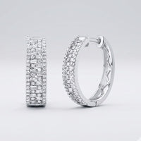 The 14k Gold Baguette Diamond Hoop Earrings 7/8CTW feature multiple rows of sparkling diamonds and are displayed on a plain light gray background.