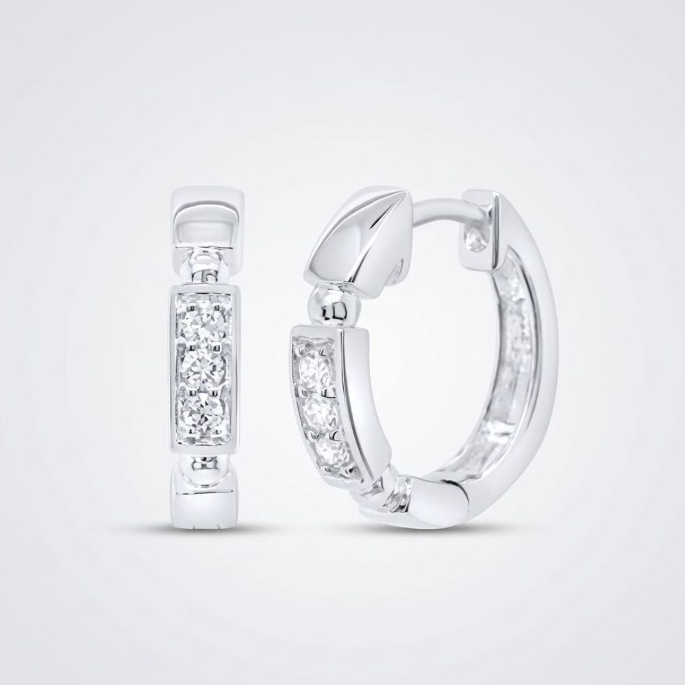 A pair of 10k gold diamond fashion hoop earrings (1/10CTW) featuring sparkling white gemstones in rectangular settings, shown on a light gray background.