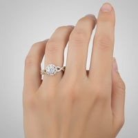 A hand with neatly manicured nails wearing the 1/2 CTW Diamond Flower Bridal Ring in 14K gold, showcasing a sparkling floral arrangement of diamonds on the ring finger against a plain light background.
