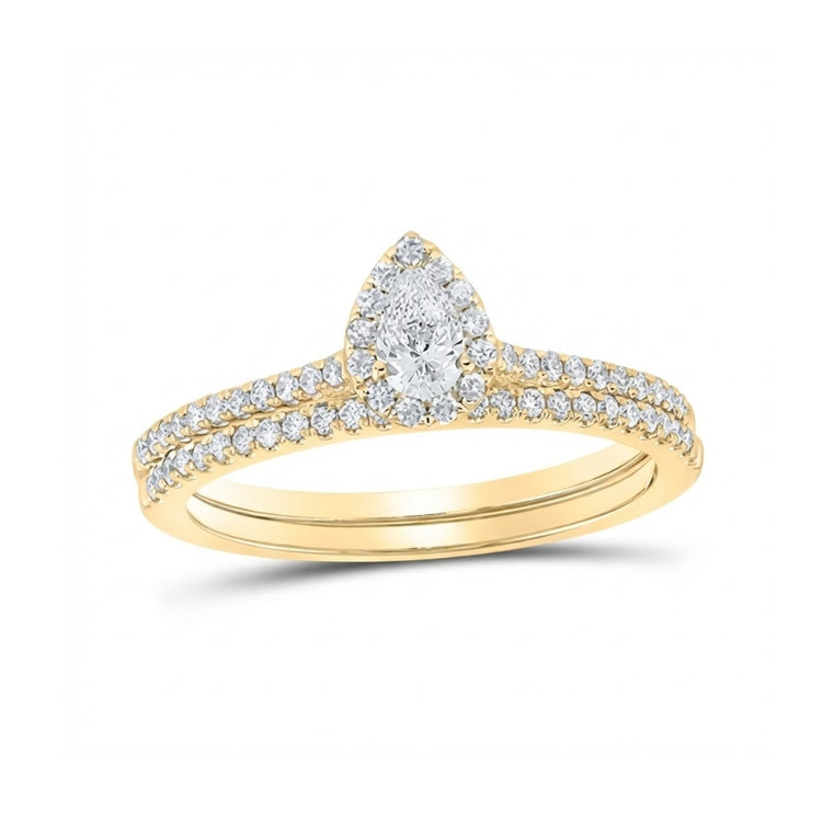 The 14k Gold Pear Diamond Halo Wedding Ring Set features a pear-shaped diamond halo center, round diamonds along the band, and comes with a matching diamond-studded gold wedding band.
