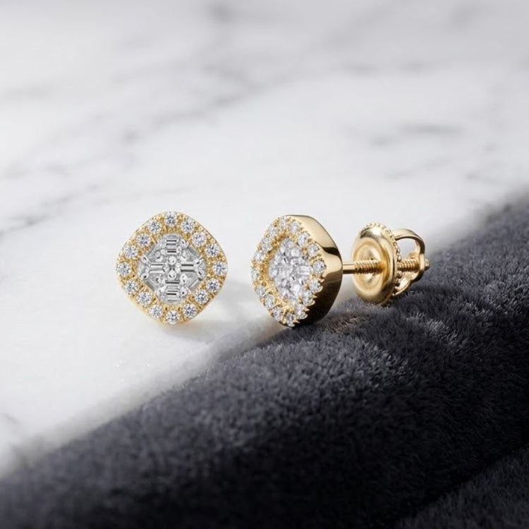 A pair of 1/6CTW Clover Diamond Earrings in 10k gold, featuring clover-shaped diamond clusters each encircled by a halo of smaller diamonds, displayed on a marble and gray velvet surface.