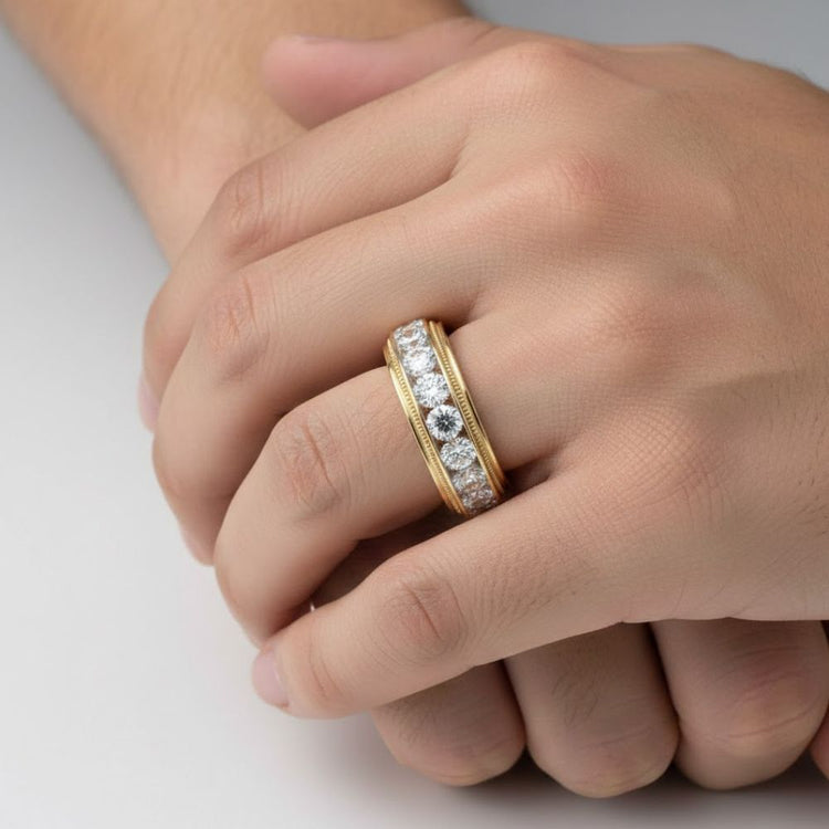 A close-up of a hand wearing the 10k Gold Round Diamond Band Ring 2 CTTW, featuring a row of sparkling diamonds set in gold, gently resting on another hand against a warm off-white studio background.