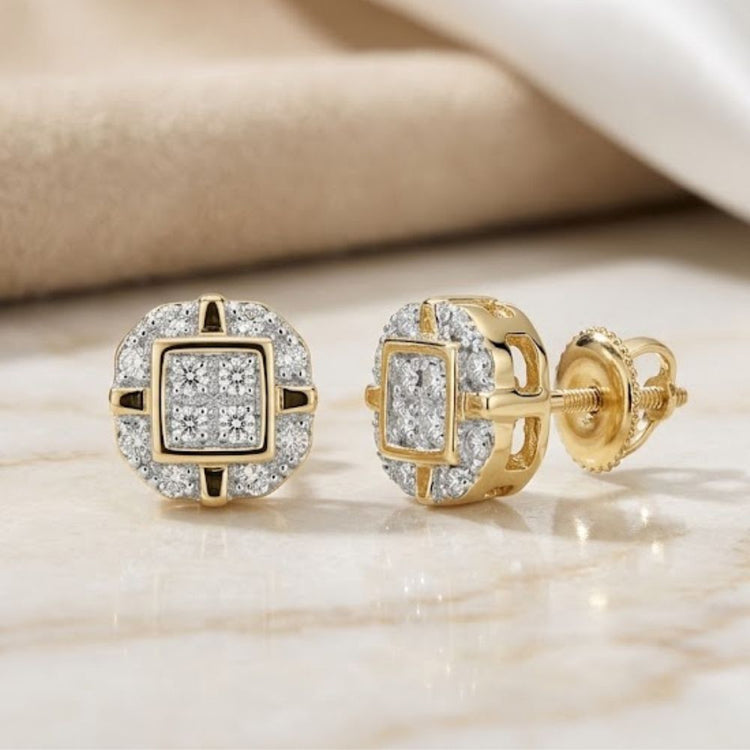 10k Gold Diamond Rounded Square Earrings 1/12 Cttw, featuring a cluster of diamonds in a rounded square design, are set on a marble surface with beige fabric in the background—an elegant addition to any fine jewelry collection.
