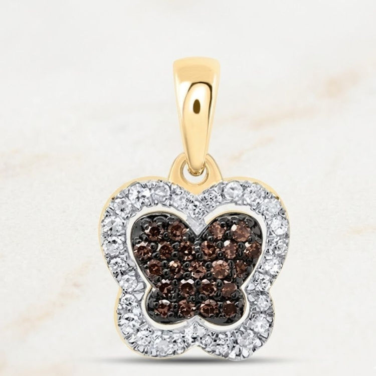 The 1/5CTW-DIA P1 Gift Cognac Natural Diamond Butterfly Pendant features a 10k gold design with cognac diamonds at the center and clear gems along the border for a dazzling look.