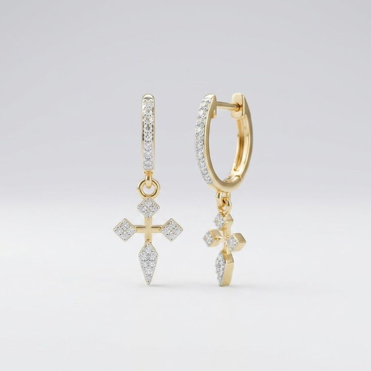 The 10k Gold Diamond Cross Hoop Dangle Earrings 1/6 Cttw feature hoop designs with cross-shaped charms, each encrusted with sparkling diamonds, shown against a plain light background.