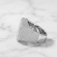 The 925 Silver Moissanite Snowflake Ring, featuring a wide sterling silver band set with sparkling moissanite stones, rests on white marble—a refined men’s fashion ring choice.