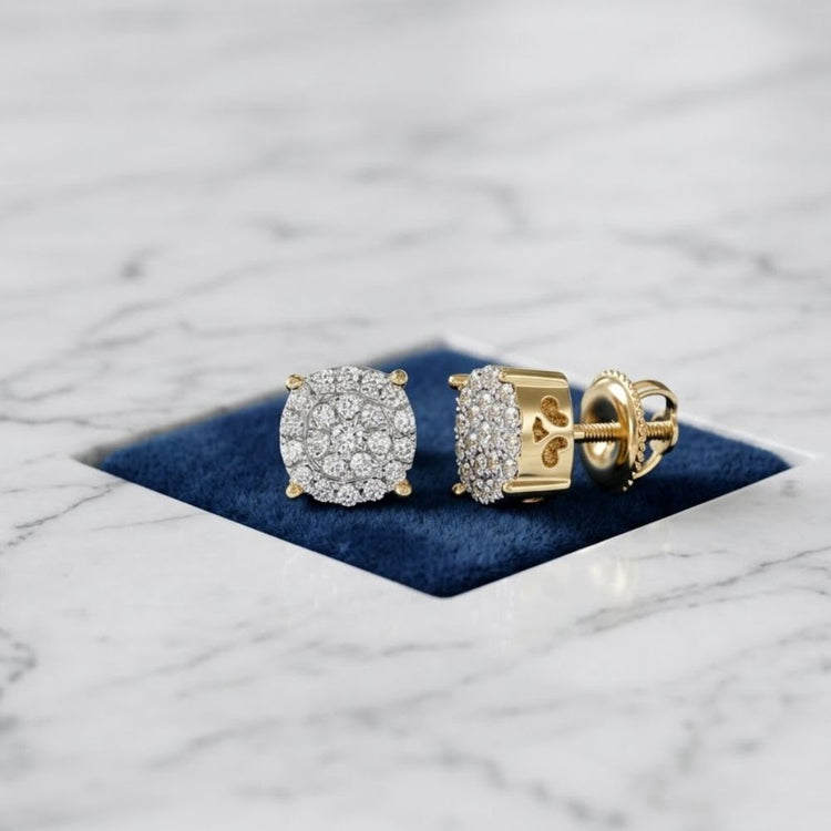 A pair of 10k Gold Diamond Cluster Earrings – 1/8 Cttw displayed on blue velvet in a marble surface cutout.