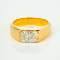 The 2 CT Radiant-Cut Diamond Statement Ring features a bold 18K yellow gold wide band with a large rectangular radiant-cut diamond at the center, displayed against a white background.