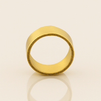 The 8mm Flat Band Ring - 24k stands upright on a neutral surface, featuring a wide matte finish, smooth exterior, subtly textured edges, and a minimalist, modern design.