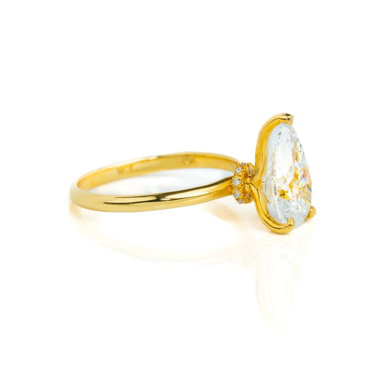 A 2.08ct pear lab diamond solitaire engagement ring in 14k yellow gold, featuring a brilliant center stone in a classic setting, shown from the side on a white background.