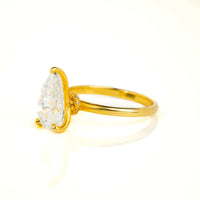 The 2.08ct Pear Lab Diamond Solitaire Engagement Ring in 14k yellow gold features a striking pear-shaped lab diamond with accent stones on the band, shown against a white background.