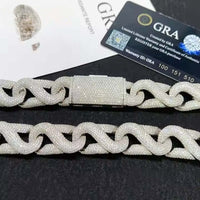 A close-up of the Ice Out Silver Moissanite Cuban Link Chain - 20mm, featuring a rectangular clasp. A GRA certificate card and authenticity report in the background emphasize the exceptional quality of this sterling silver bracelet.