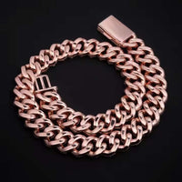 The Rose Gold Moissanite Cuban Link Chain - 20mm, featuring a rectangular clasp, is shown coiled on a black surface.