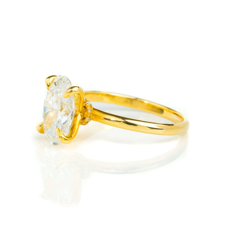 A 1.72ct oval-cut lab diamond engagement ring in 14k solid yellow gold with a prong setting, displayed on a white background.