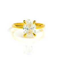 The 1.72ct oval-cut lab diamond engagement ring, set in 14k solid yellow gold, features a solitaire stone held by four prongs and is displayed on a white background.
