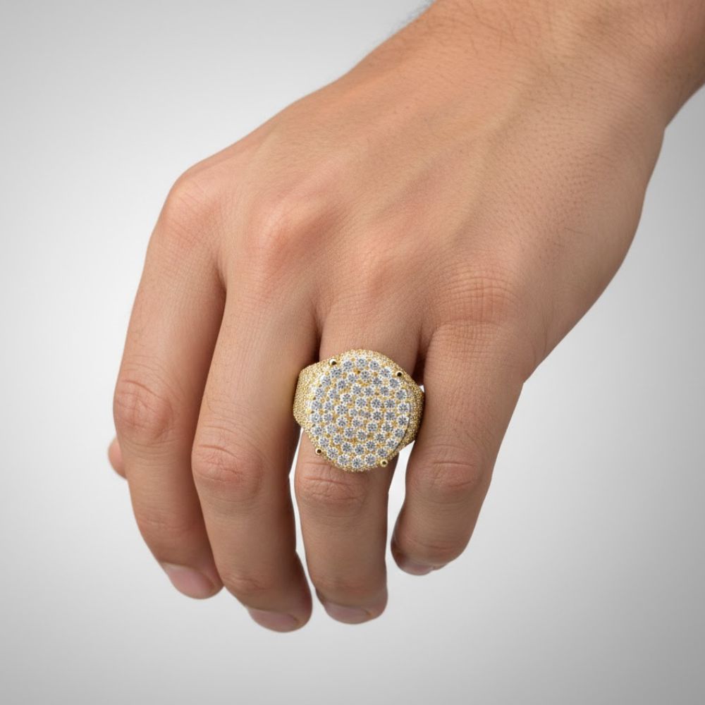 A hand displays the Round Pavé Diamond Ring – 4.58 CT Gold Design, featuring multiple rows of sparkling clear stones, set against a simple light background.