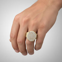 A hand displays the Round Pavé Diamond Ring – 4.58 CT Gold Design, featuring multiple rows of sparkling clear stones, set against a simple light background.