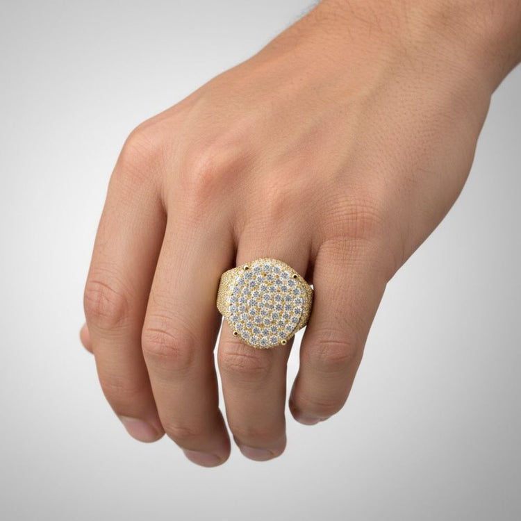 A hand displays the Round Pavé Diamond Ring – 4.58 CT Gold Design, featuring multiple rows of sparkling clear stones, set against a simple light background.