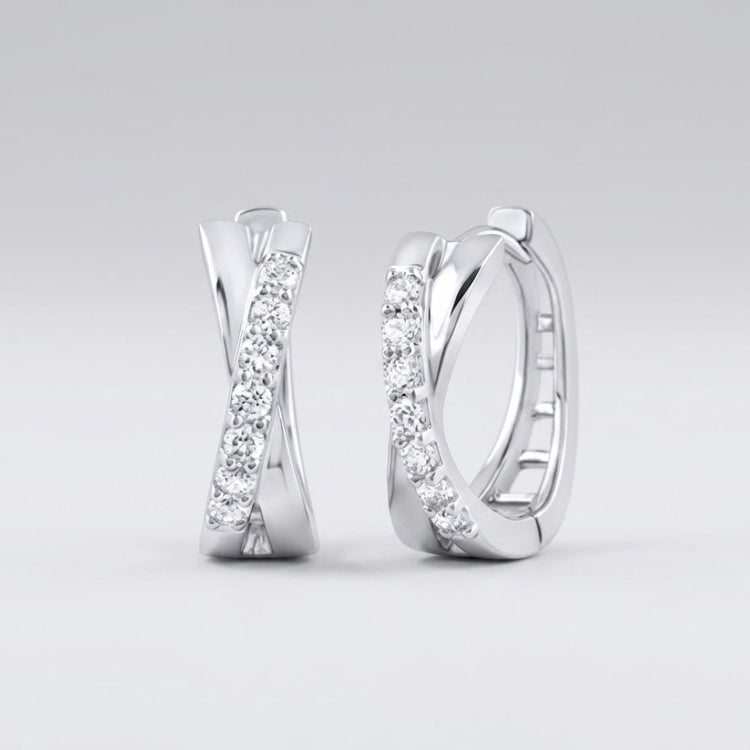The 10k Gold Round Diamond Hoop Earrings – 1/6 Cttw showcase an elegant crisscross design with sparkling round diamonds set on the front, displayed against a plain light grey background.