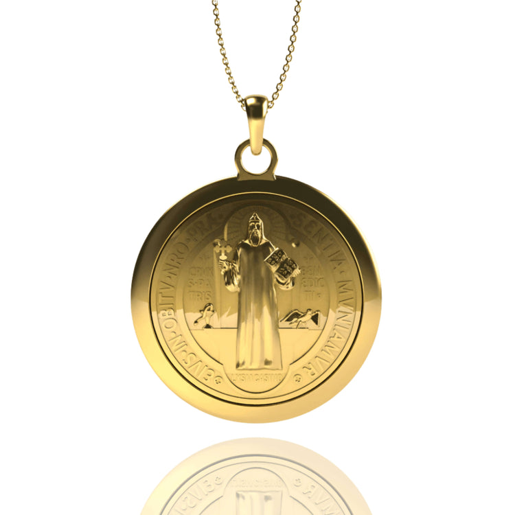 The 14k Gold Saint Benedict Pendant features an engraved image of Saint Benedict holding a book and cross, with detailed Latin inscriptions, hanging from a delicate chain.