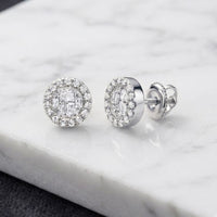 A pair of 1/5CTW Diamond Earrings in 10K gold, featuring round and baguette diamonds in a halo setting, displayed on a white marble surface.