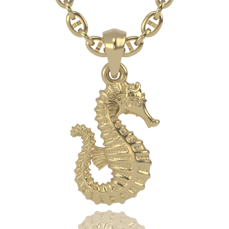 The 14k Gold Seahorse Pendant features intricate ridges and a lifelike design, hanging from a rounded chain and displayed against a white background.