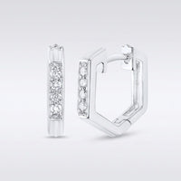 A pair of 10k Gold Diamond Fashion Hoop Earrings (1/8CTW), hexagonal in shape, displayed on a plain background. One earring faces forward, showing a row of sparkling diamonds; the other is open to reveal the clasp.