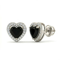 The Heart Black Onyx Diamond Earrings 1/5CTW 10k Gold feature large black onyx hearts at the center, bordered by sparkling diamonds, and set in luxurious 10k gold.