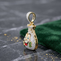The 10K Gold Diamond Money Bag Men’s Charm 1/2CTW features a smiling money bag with cartoon eyes, crown, heart-shaped mouth, green dollar sign, and sparkling diamonds—shown on dark marble next to a green cloth.