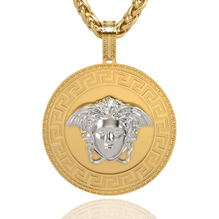 The 14k Two-Tone Gold Medusa Pendant showcases a round medallion with a Greek key border and raised silver Medusa head, all hanging from a bold gold rope chain.