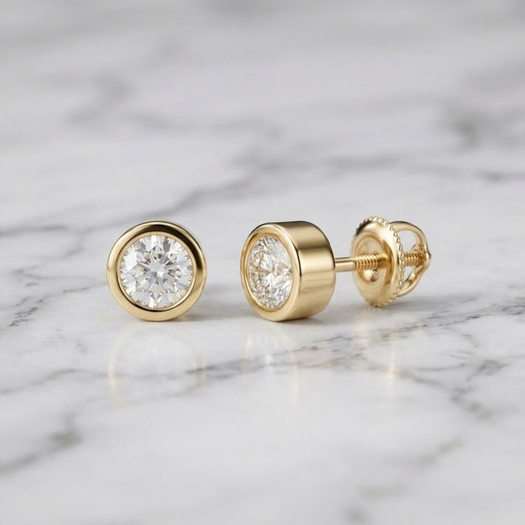 3/4CTW Natural Diamond Solitaire Stud Earrings featuring round-cut natural diamonds in 14k gold bezel settings.