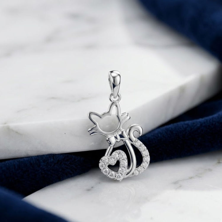 The 1/10 CTW Diamond Heart Cat Pendant in 10K Gold, shaped like a cat with a bow and heart-shaped tail and accented with sparkling diamonds, is an elegant gift for cat lovers.