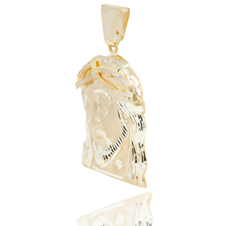The Jesus Piece Pendant in 10K Gold – Men’s Gold Pendant features a diamond-studded crown of thorns, shown against a white background with a soft reflection—an iconic choice for men's jewelry.