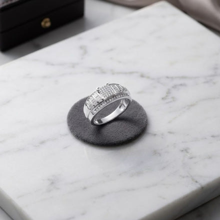 The Sterling Silver Diamond Cluster Bridal Engagement Ring is displayed on a round, dark pad atop a white marble surface.