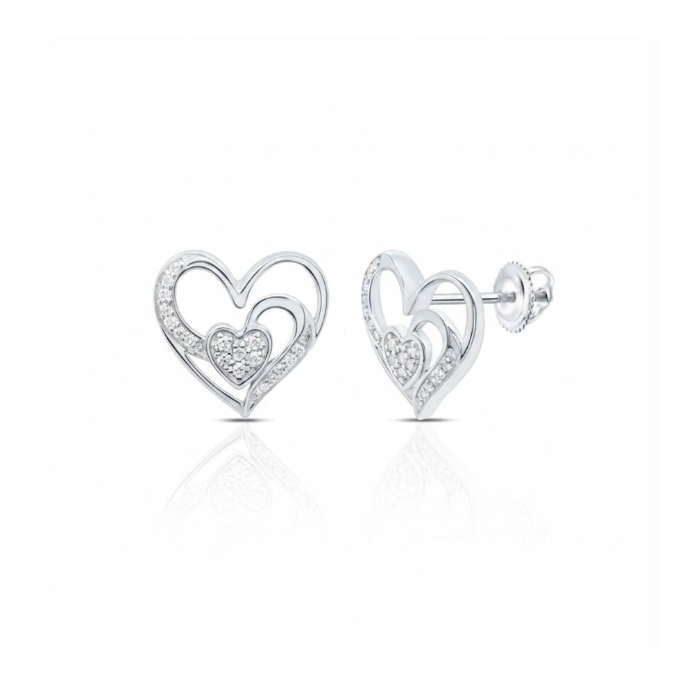 The 1/10 CTW Natural Diamond Heart Earrings are silver, heart-shaped studs with an open heart design and a smaller pavé diamond heart inside. They feature a polished finish and secure post with butterfly backs.